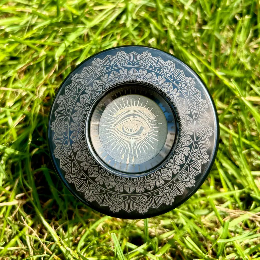 Pop-Vac lid with custom laser etching — mandala pattern with all-seeing eye design on the disc